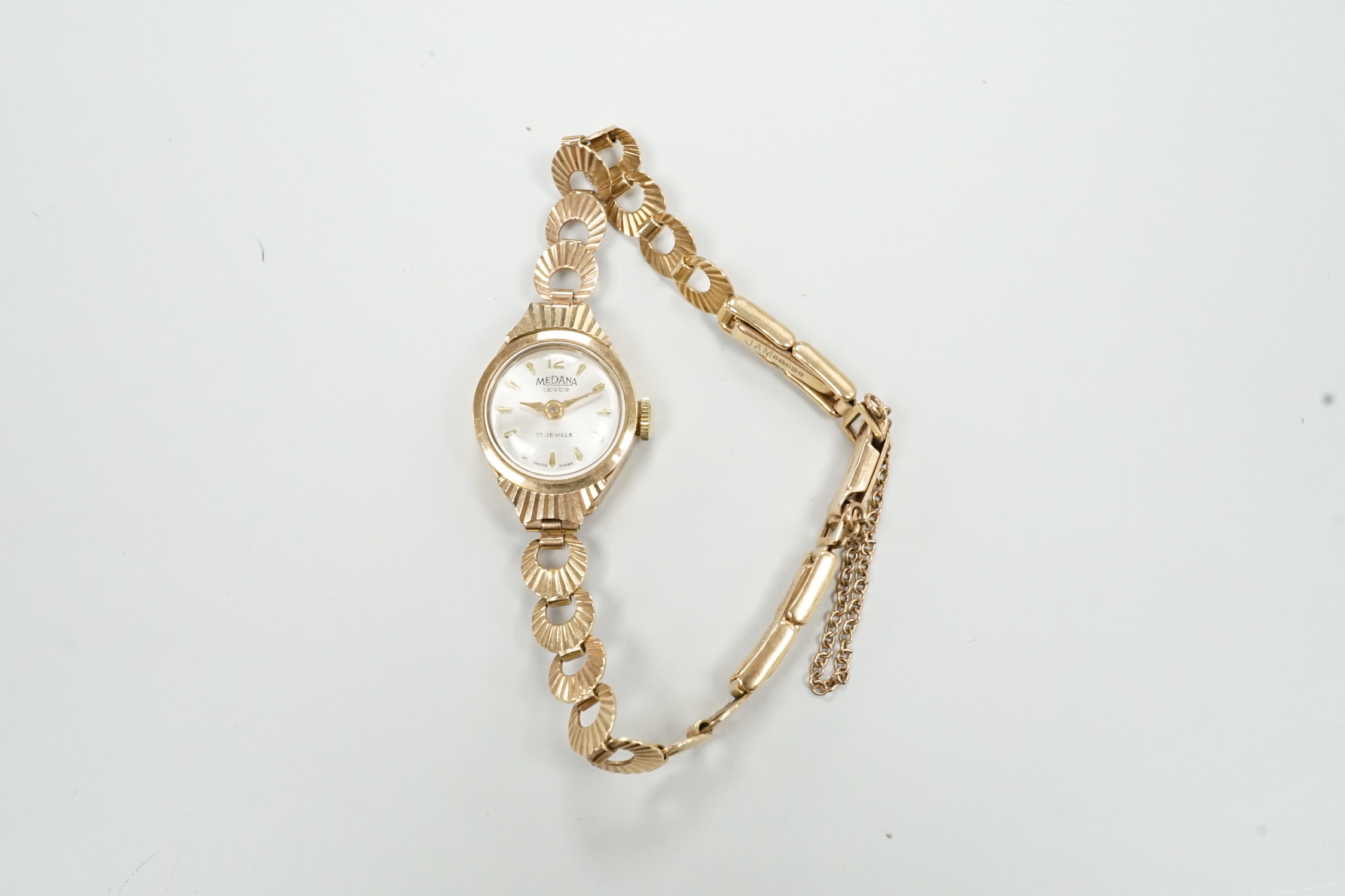 A lady's 9ct gold Medana manual wind wrist watch, on a 9ct gold bracelet